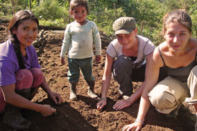 Students Heather Bell and Peggy Lucas (in hat) prepare a garden with new friends - photo courtesy of Peggy Lucas
