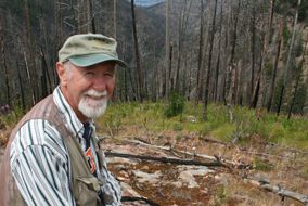 Maury Williams overlooks an area of Myra Canyon that was devastated by forest fire in 2003 - photo by Jody Jacob