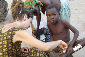 UBC nursing grad Chloe Lemire-Elmore treats a young Ghanian patient